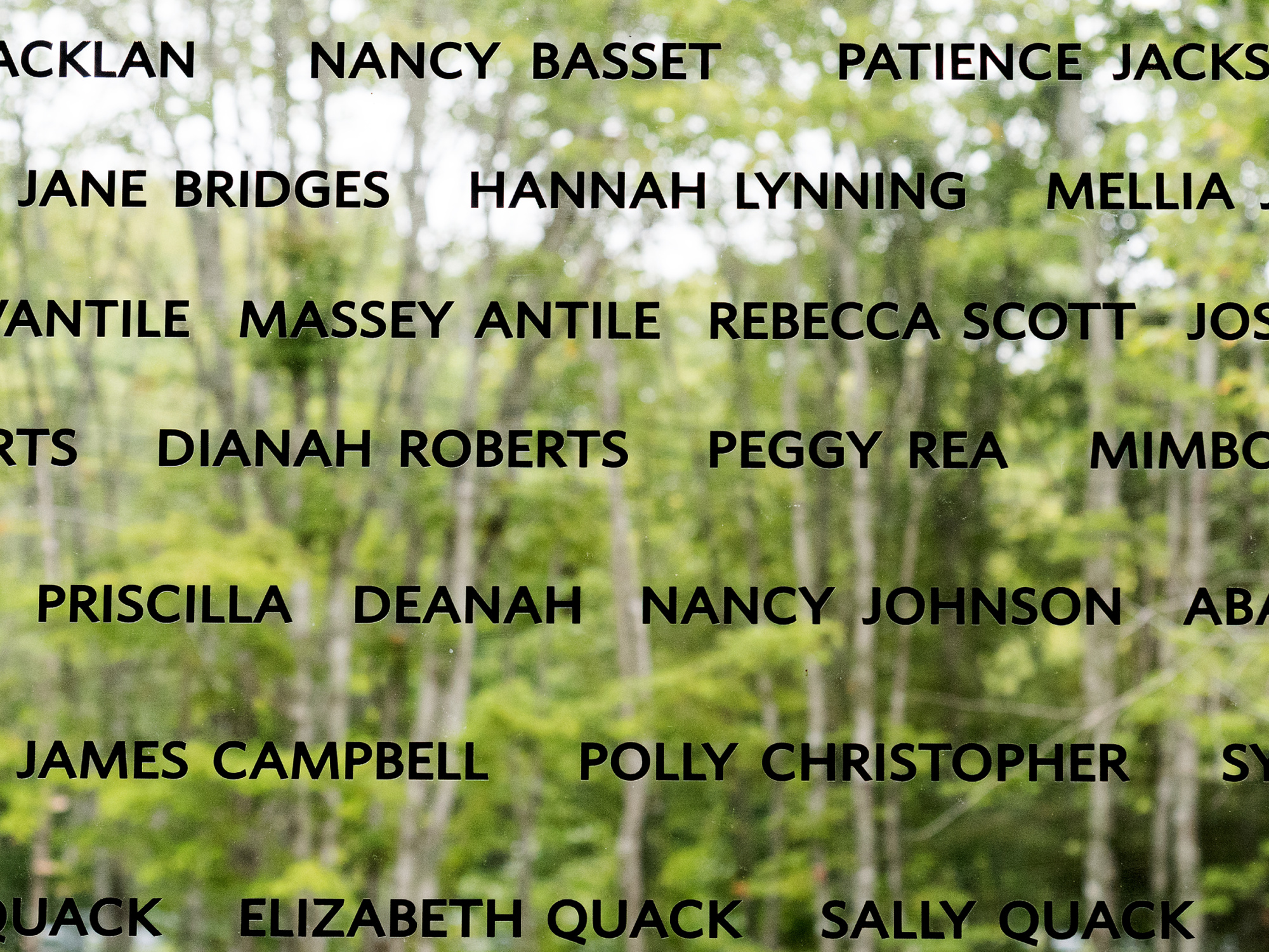 Names of the Black Loyalists etched into a wall of windows.