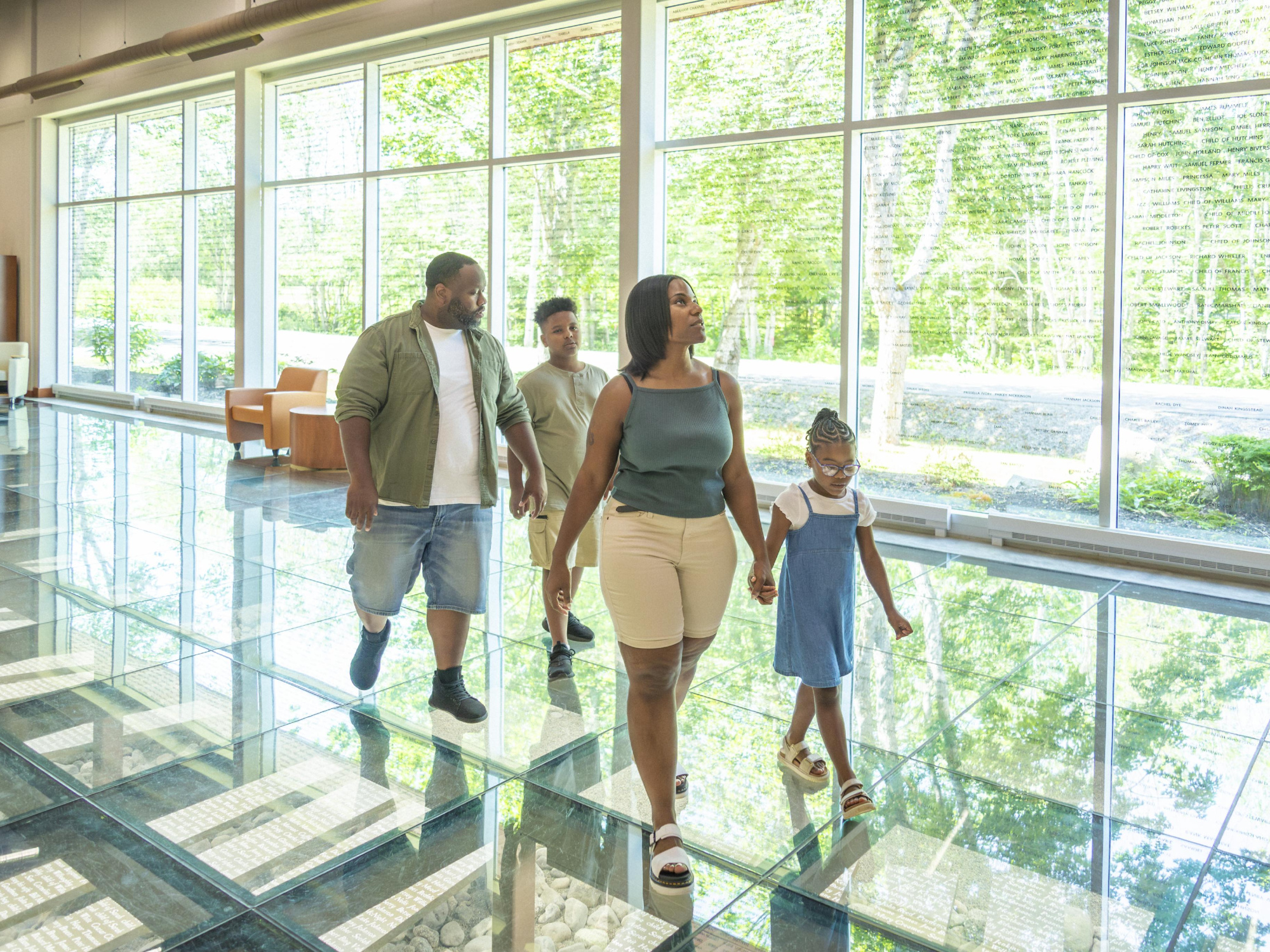 Family walking across the glass floor at the Black Loyalist Heritage Centre 