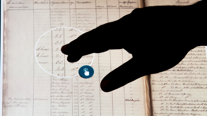 A hand navigating a virtual copy of the Book of Negroes.